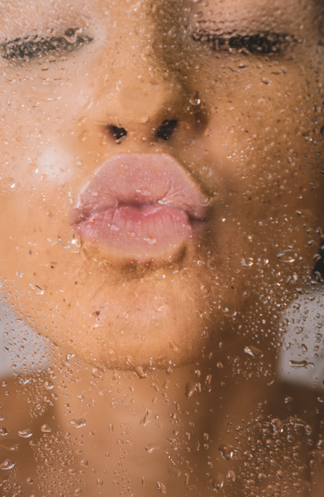 image of person kissing wet glass for alter planning co's blog on moisture barrier